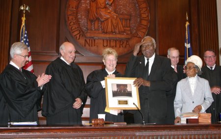 Group Photo of Justices and Ben McCall saluting the court